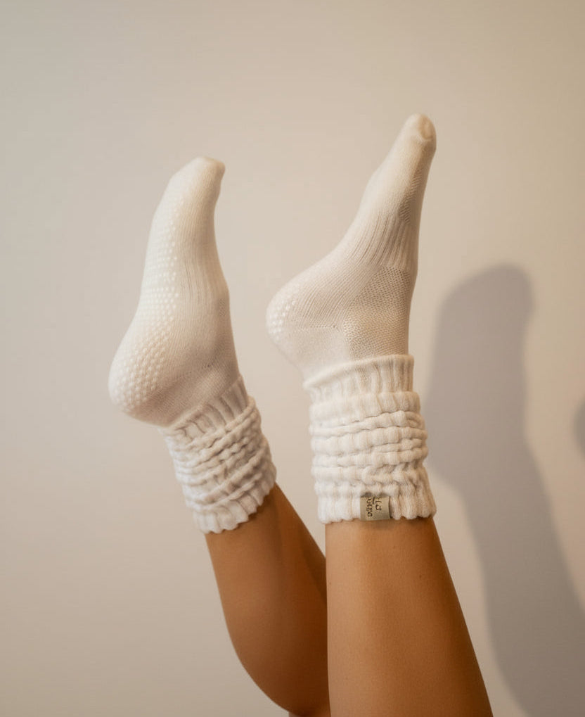 White textured socks worn by a person against a plain background